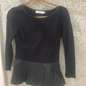 Fitted upper portion, ￼ ￼flare bottom of shirt with leather bottom